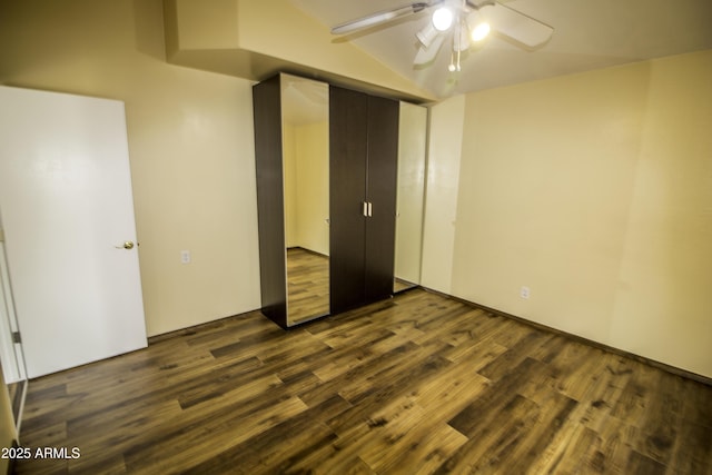 20221 N 31st St, Phoenix, AZ 85050 - unfurnished bedroom with dark wood-style flooring, lofted ceiling, and a ceiling fan