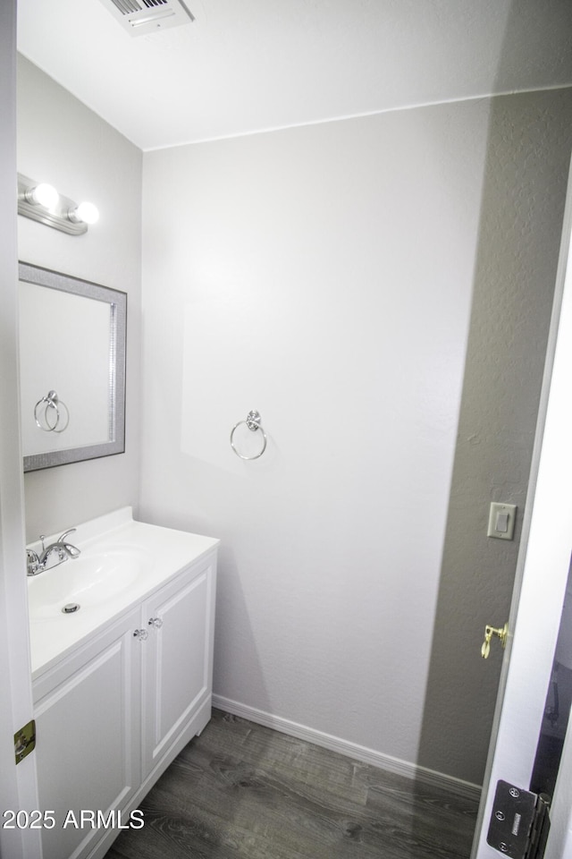 20221 N 31st St, Phoenix, AZ 85050 - bathroom featuring wood finished floors, vanity, and baseboards