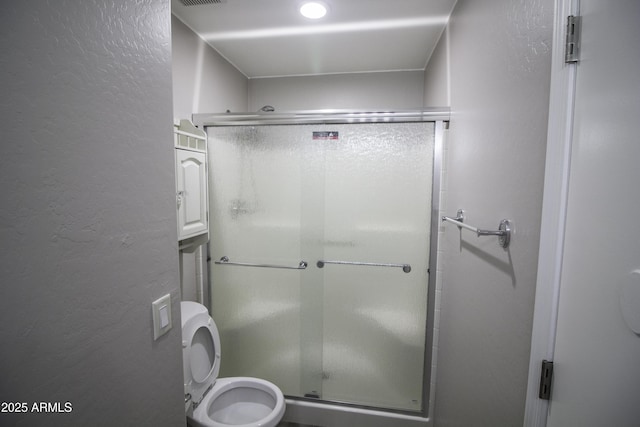 20221 N 31st St, Phoenix, AZ 85050 - bathroom with a textured wall, a stall shower, and toilet