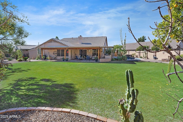 back of property featuring a patio and a lawn