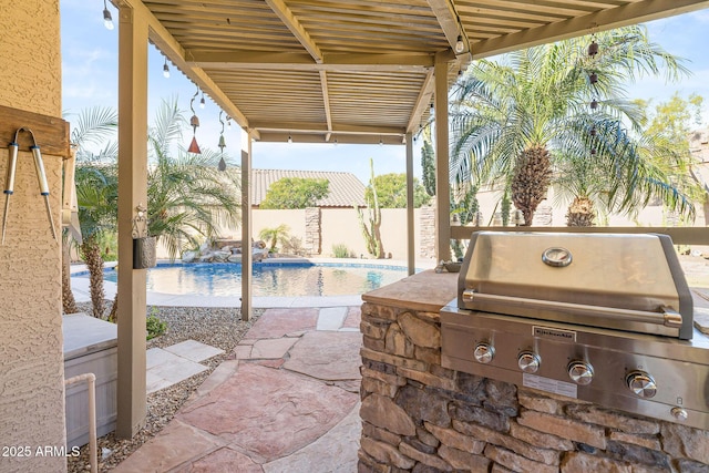 view of patio with an outdoor kitchen, a grill, and a fenced in pool