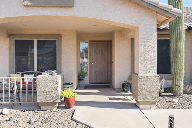 view of exterior entry featuring a patio