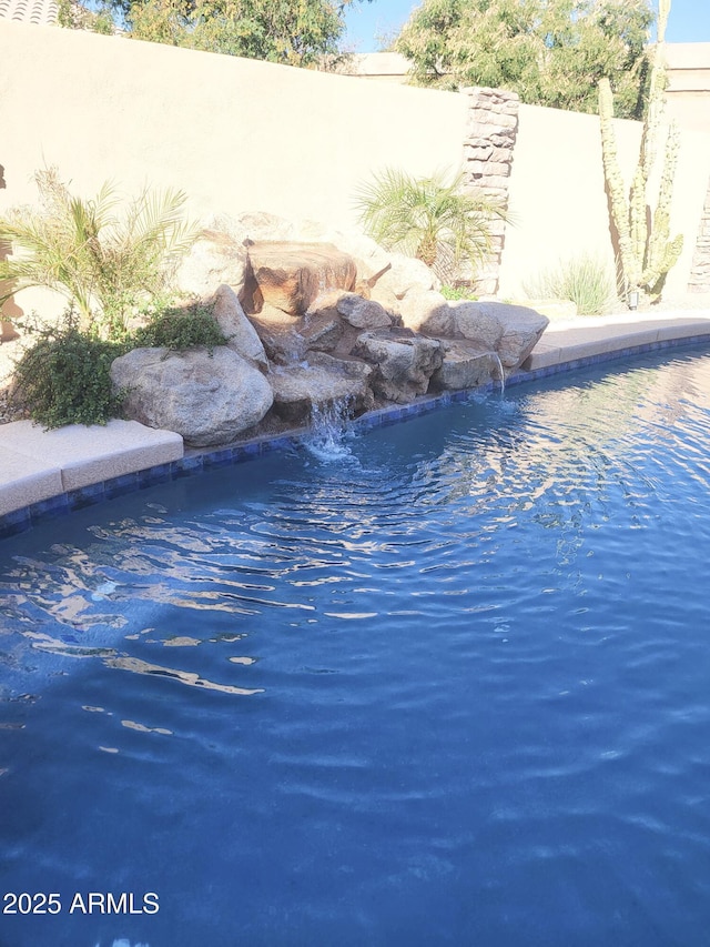 view of pool with pool water feature