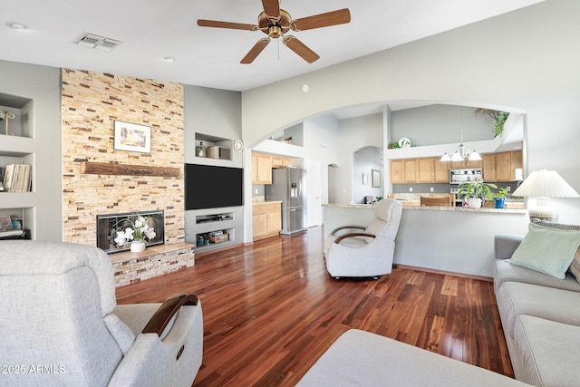 living room with vaulted ceiling, built in features, and dark hardwood / wood-style floors