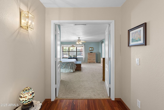 hallway with hardwood / wood-style floors