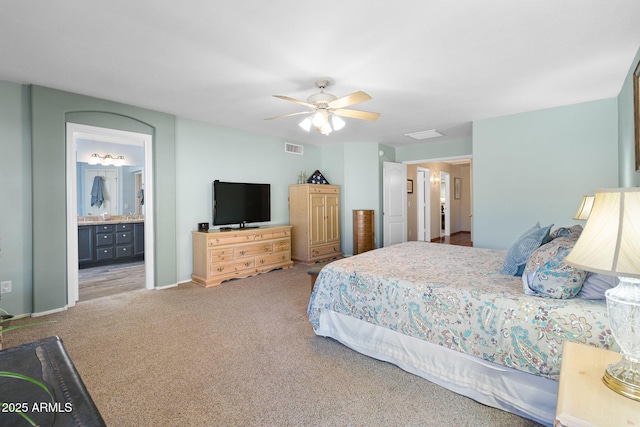 carpeted bedroom featuring connected bathroom and ceiling fan