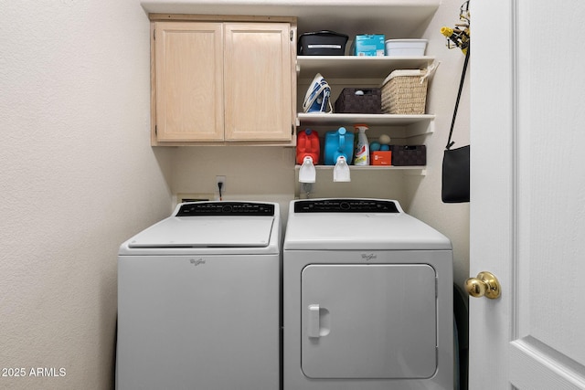 laundry room featuring cabinets and washer and dryer