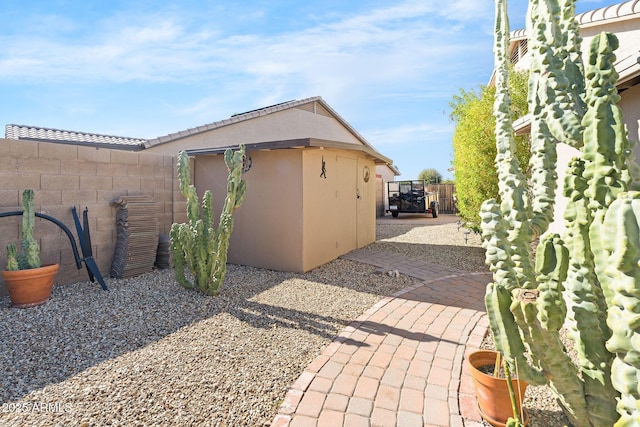 view of property exterior with a shed