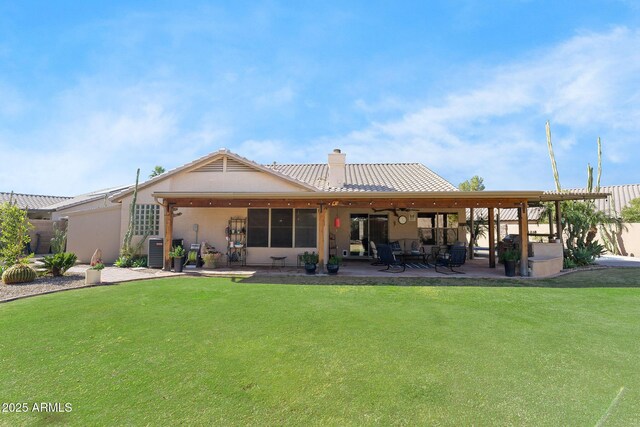 rear view of property with central AC unit, a lawn, and a patio area