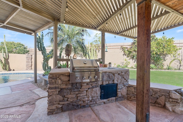 view of patio with exterior kitchen, a fenced in pool, grilling area, and a pergola