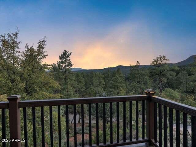 view of mountain background with a heavily wooded area
