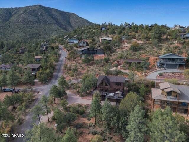 aerial view of property's location featuring a mountainous background