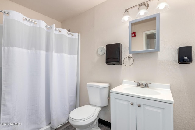 full bathroom with toilet, curtained shower, and vanity