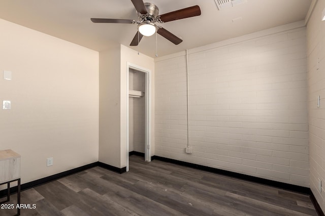 unfurnished bedroom with a ceiling fan, visible vents, dark wood finished floors, and baseboards