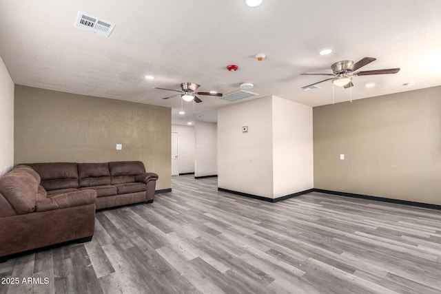 living area with baseboards, visible vents, a ceiling fan, wood finished floors, and recessed lighting