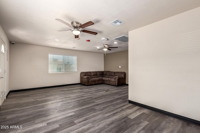 unfurnished living room with visible vents, baseboards, and wood finished floors