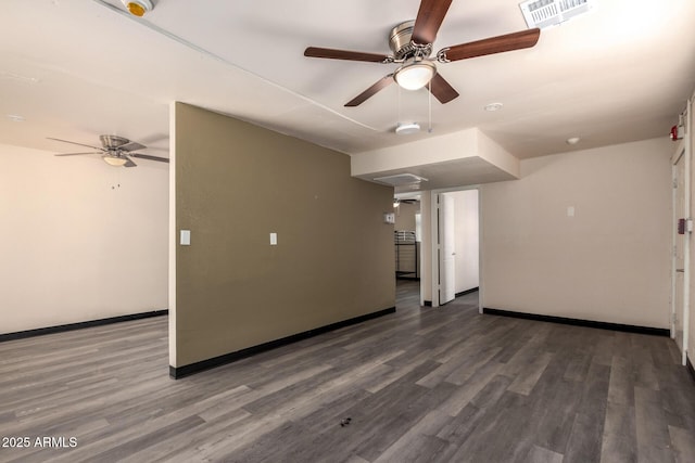 unfurnished living room with baseboards, visible vents, ceiling fan, and wood finished floors