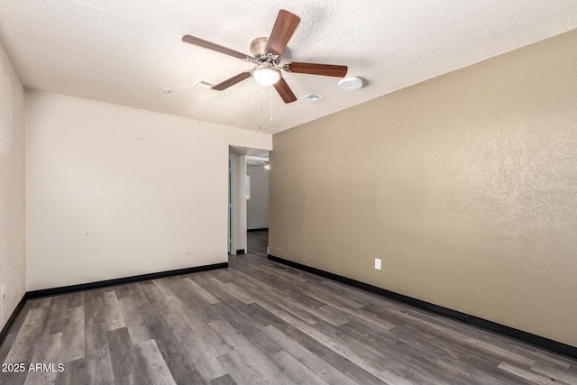 spare room with visible vents, ceiling fan, a textured ceiling, wood finished floors, and baseboards