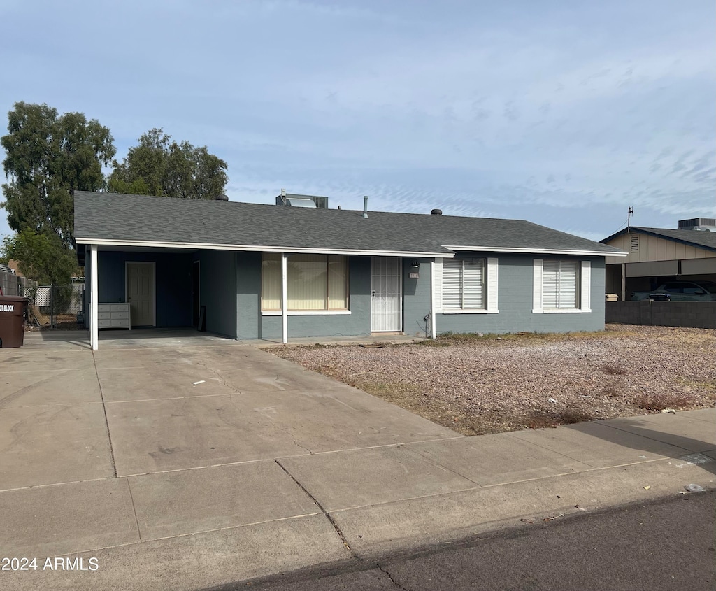 single story home featuring a carport