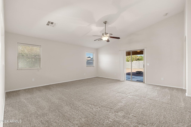 carpeted empty room featuring ceiling fan and lofted ceiling