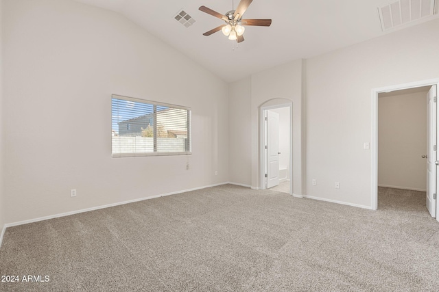 unfurnished bedroom with a walk in closet, ceiling fan, and light colored carpet