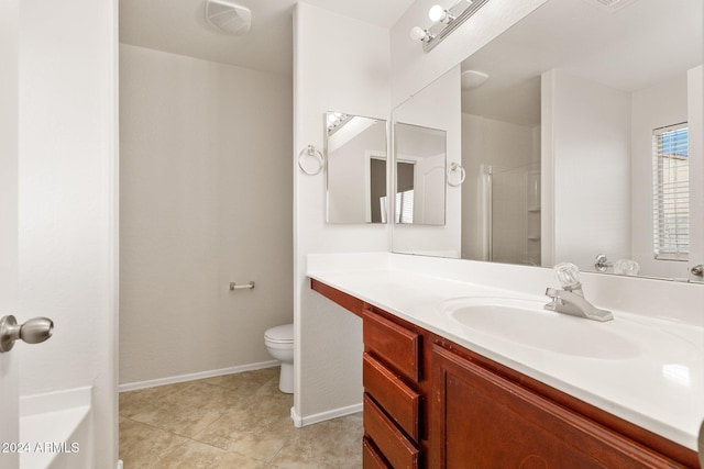 bathroom with tile patterned flooring, vanity, toilet, and walk in shower