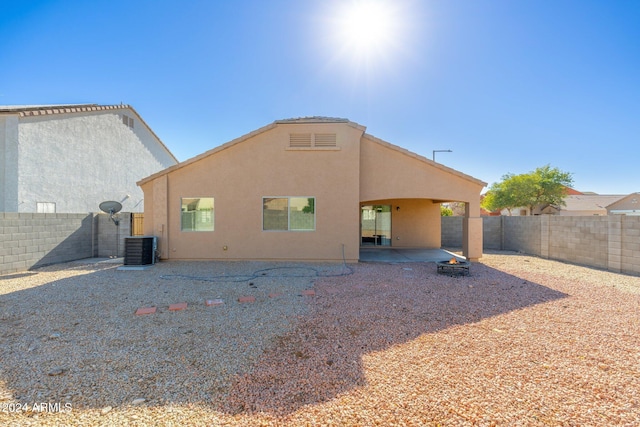 rear view of property featuring cooling unit and a patio area