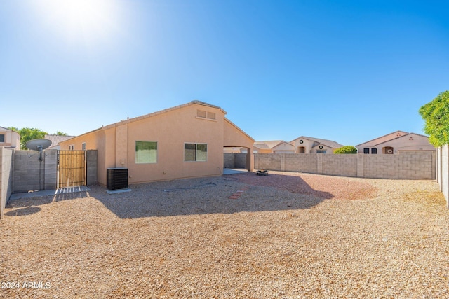 rear view of property featuring central AC unit