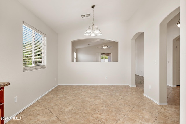 empty room with light tile patterned floors, ceiling fan with notable chandelier, and vaulted ceiling