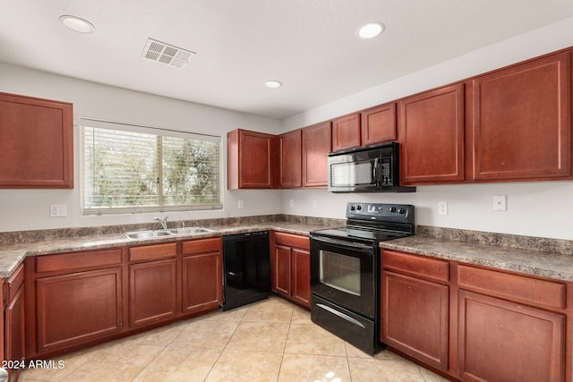 kitchen featuring sink, light tile patterned floors, and black appliances