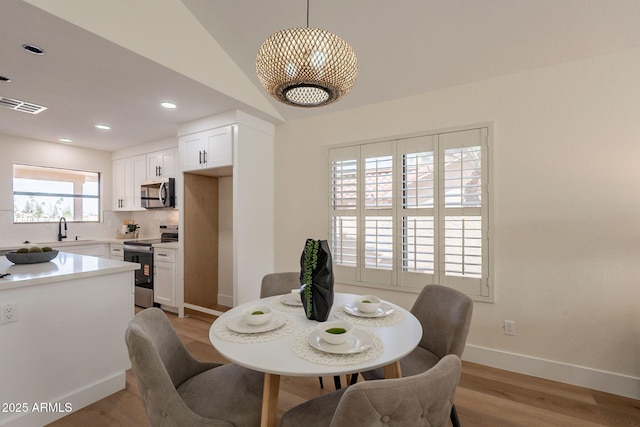 dining space featuring light wood-type flooring, recessed lighting, baseboards, and visible vents
