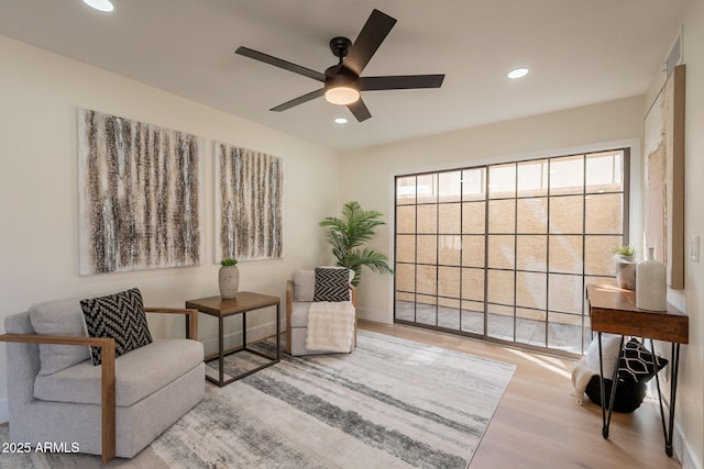 sitting room with ceiling fan, recessed lighting, and wood finished floors