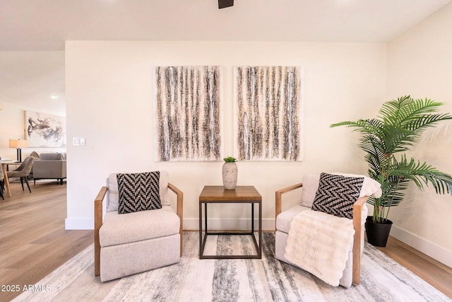 living area with wood finished floors and baseboards