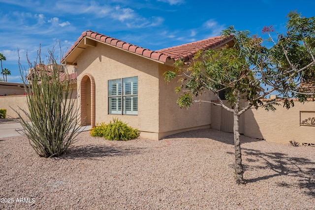 view of home's exterior featuring stucco siding and a tiled roof