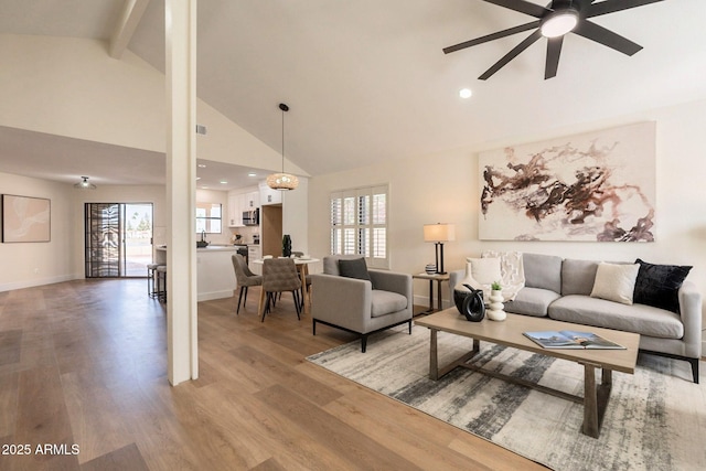 living room with recessed lighting, light wood finished floors, ceiling fan, and high vaulted ceiling