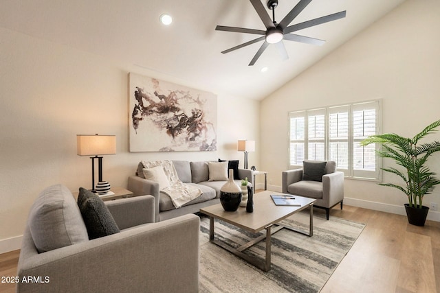 living area with a ceiling fan, recessed lighting, light wood-style floors, and high vaulted ceiling