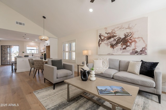 living room featuring visible vents, recessed lighting, ceiling fan, light wood-style flooring, and baseboards