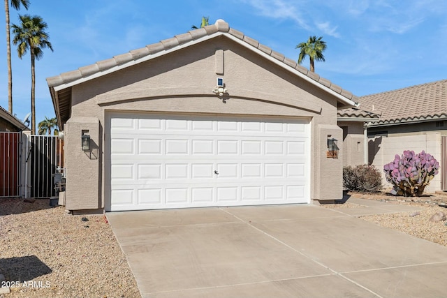 garage with driveway and fence