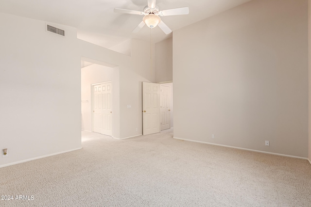 spare room with ceiling fan and light colored carpet