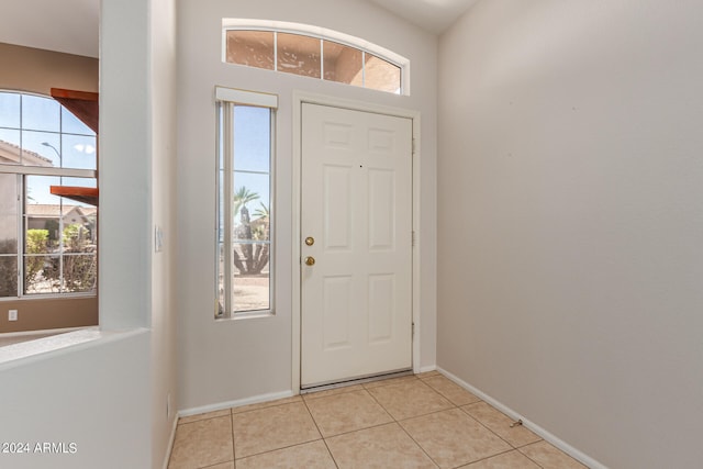 tiled foyer featuring a healthy amount of sunlight