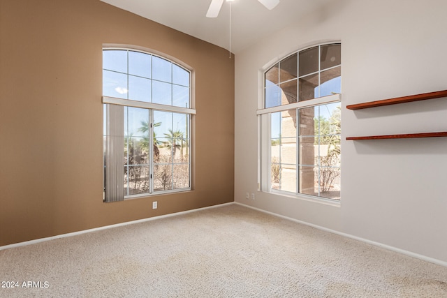 carpeted empty room with ceiling fan and a healthy amount of sunlight