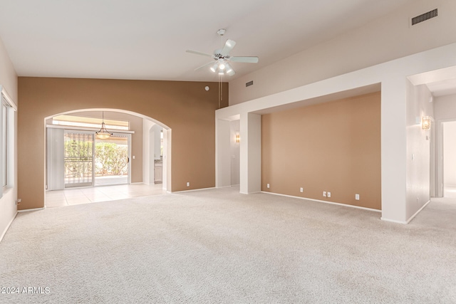 unfurnished living room with light carpet, lofted ceiling, and ceiling fan