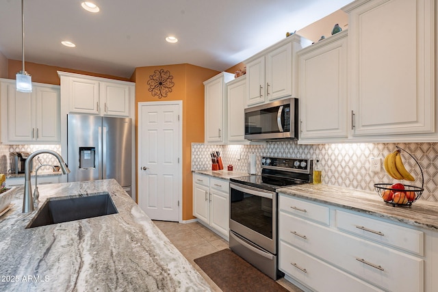 kitchen featuring white cabinets, appliances with stainless steel finishes, and a sink