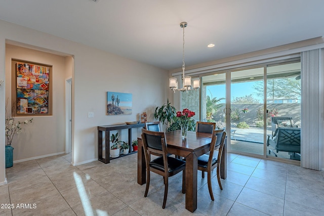 dining area with light tile patterned flooring, baseboards, and a chandelier