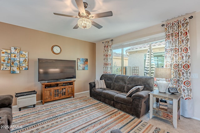 living room featuring baseboards and a ceiling fan