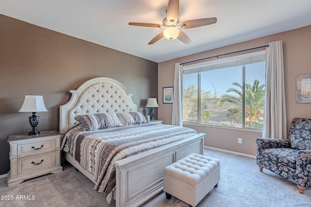 bedroom with light colored carpet, baseboards, and ceiling fan