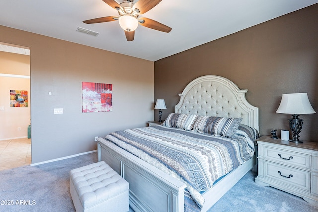 bedroom with visible vents, baseboards, light colored carpet, and a ceiling fan