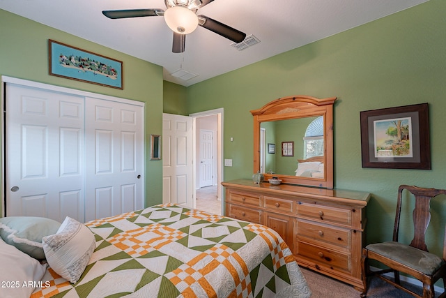 carpeted bedroom with visible vents, a closet, and ceiling fan