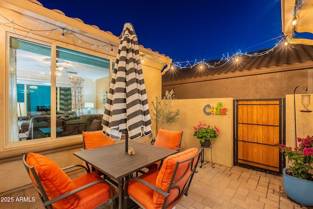 patio at twilight featuring outdoor dining area