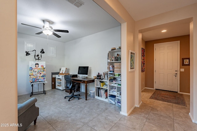 office with light tile patterned floors, visible vents, a ceiling fan, and baseboards